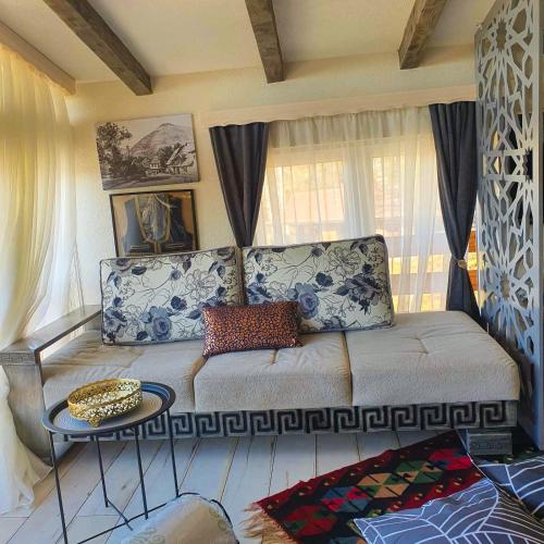 a living room with a couch and a table at Apartment Little Paradise in Visoko