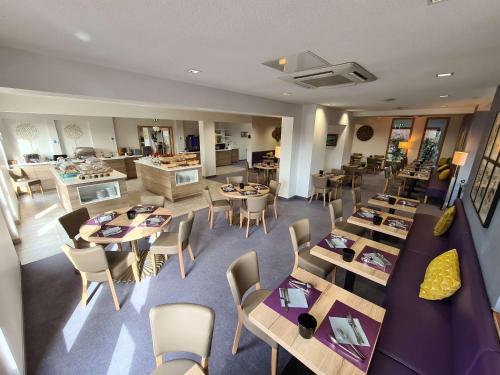 an overhead view of a restaurant with tables and chairs at Best Western Plus Hotel & SPA Le Schoenenbourg in Riquewihr
