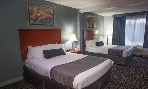 a hotel room with two beds and a window at Parke Regency Hotel & Conf Ctr., BW Signature Collection in Bloomington