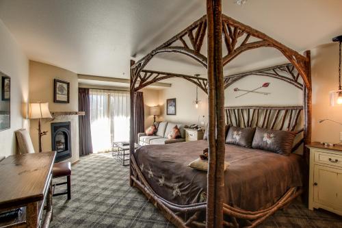 a bedroom with a large bed and a living room at Bavarian Lodge in Leavenworth