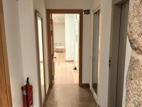 a hallway with a door leading to a bathroom at Belvilla by OYO Villa Trabazos Abellas in Ourense