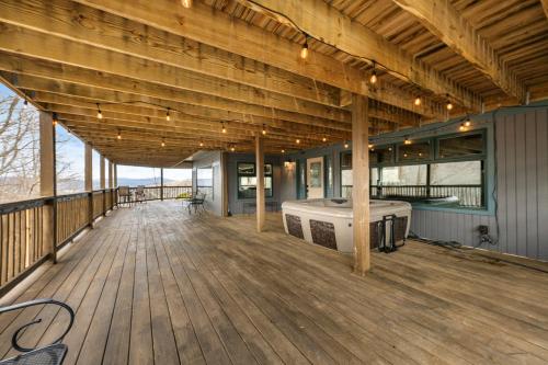 a large deck with a hot tub on it at High Y'all! in Banner Elk
