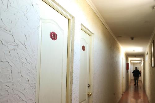 a person walking down a corridor in a hallway at Hotel Terramar in Talcahuano