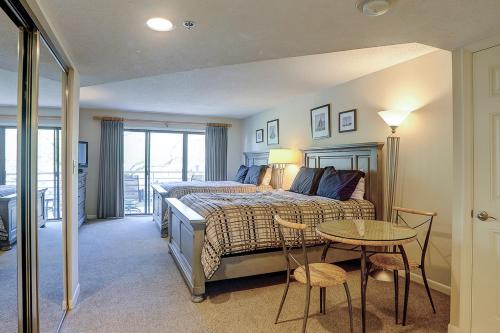 a bedroom with a bed and a table and chairs at Villamare 2319 in Hilton Head Island