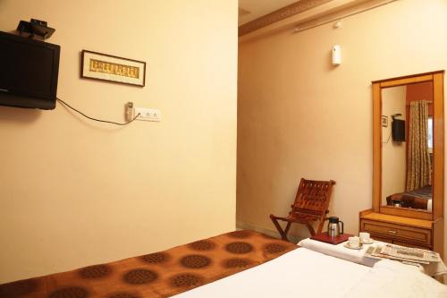 Televisyen dan/atau pusat hiburan di Hotel Meenakshi Udaipur - Family Preffered Hotel