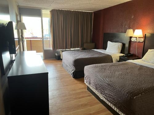 a hotel room with two beds and a window at Knights Inn Ashland in Ashland