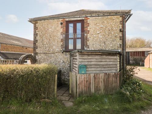 a house with a wooden gate and a window at The Granary in Henfield