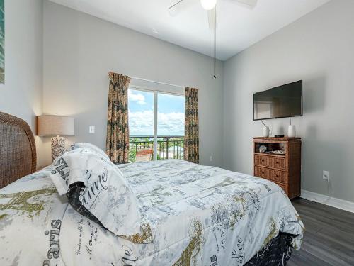 a bedroom with a bed and a tv and a window at Madeira Bay Resort II by Travel Resort Services in St Pete Beach
