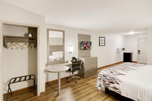 une chambre d'hôtel avec un lit et un bureau et un bureau dans l'établissement Red Roof Inn & Suites Pensacola-NAS Corry, à Pensacola