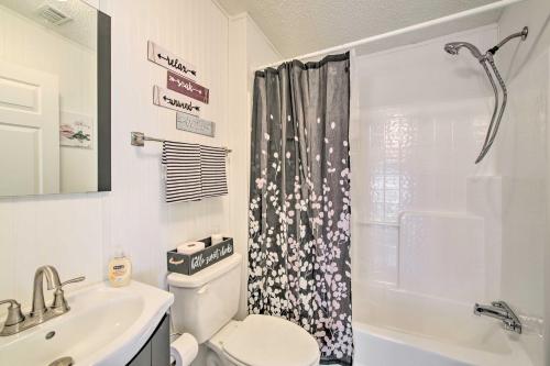 a bathroom with a toilet and a sink and a shower at Sebastien Cottage with Screened Porch, 5 Mi to Beach in Sebastian