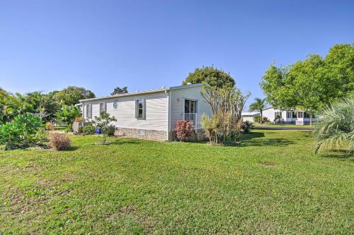 a house in a yard with a grass field at Sebastien Cottage with Screened Porch, 5 Mi to Beach in Sebastian