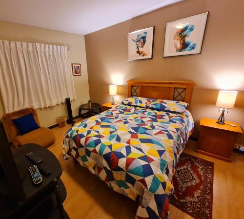 a bedroom with a bed with a colorful comforter at Miraflores Dpto 2 dorm. espaciosos 4 huéspedes 90m2 in Lima