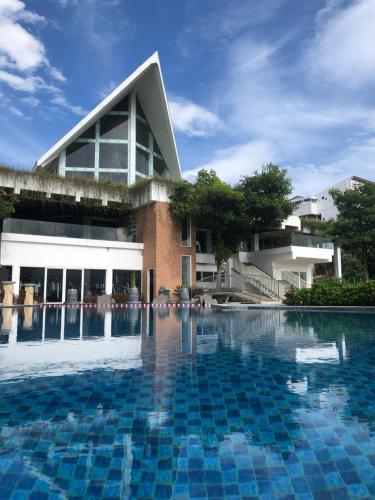 a swimming pool in front of a building at Amartahills Hotel and Resort in Batu