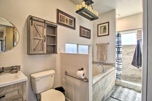 a bathroom with a toilet and a sink at Near White Mountain Lake Home with Balcony and Patio in Show Low