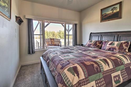 a bedroom with a bed and a window at Near White Mountain Lake Home with Balcony and Patio in Show Low