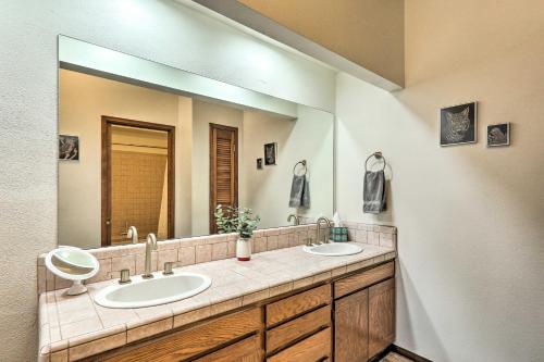 a bathroom with two sinks and a large mirror at Beautiful Saguaro Vista with Mountain Views! in Tucson
