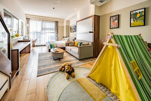 a living room with a dog laying on the floor at Kunming Xingyao Hotel in Kunming