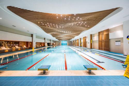 a large swimming pool with a row of lanes at Kunming Xingyao Hotel in Kunming