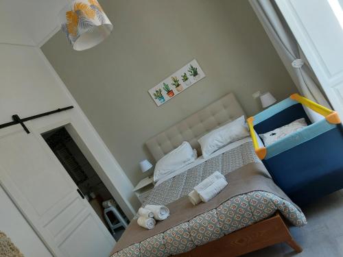 a small bedroom with a bed with a blue crib at Sapore di Sale - Sicily Rooms in Siracusa
