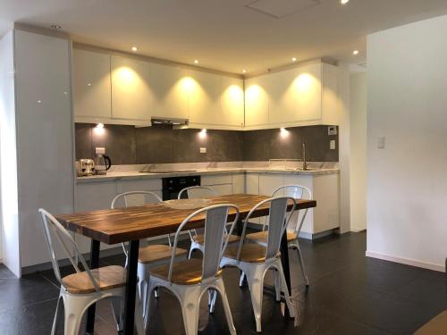 a kitchen with a wooden table and chairs at Ski-in, Ski-out House in Hakuba in Hakuba