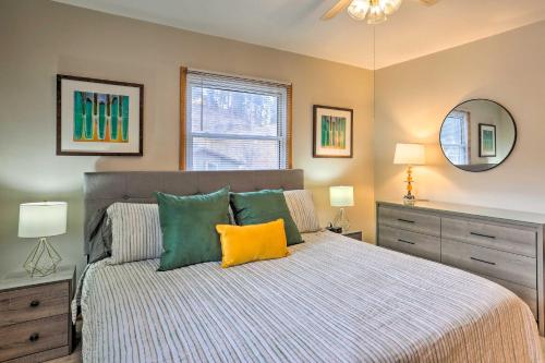 a bedroom with a bed with green and yellow pillows at Sleek Deadwood Getaway Less Than 1 Mi to Downtown! in Deadwood