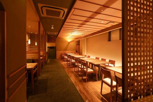 a row of tables and chairs in a restaurant at HOTEL MYSTAYS Kyoto Shijo in Kyoto