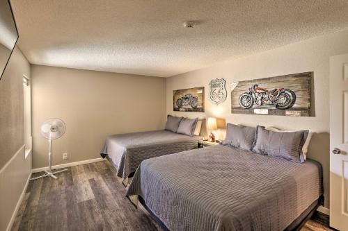 a hotel room with two beds and a motorcycle on the wall at Lake Havasu City Condo with Resort Amenities! in Lake Havasu City