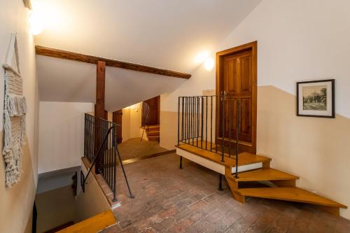 a staircase in a house with a stair case at Penzion Maštal in Český Krumlov