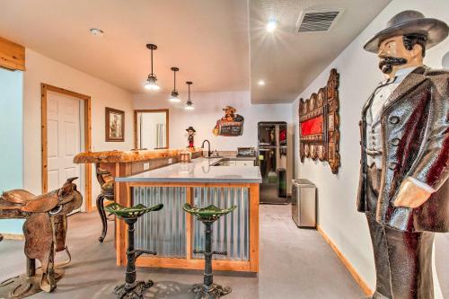a room with a kitchen with a mannequin and a counter at Family Game Room Spacious Overgaard Cabin in Overgaard