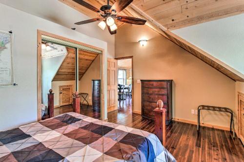 a bedroom with a bed and a ceiling fan at Family Game Room Spacious Overgaard Cabin in Overgaard