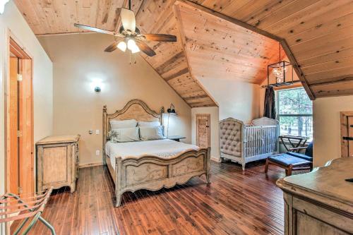 a bedroom with a bed and a ceiling fan at Family Game Room Spacious Overgaard Cabin in Overgaard