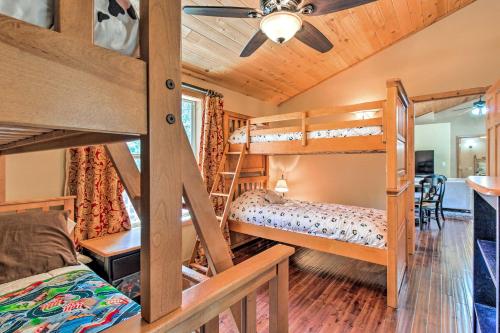 a bedroom with two bunk beds and a dining room at Family Game Room Spacious Overgaard Cabin in Overgaard