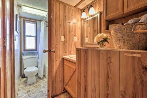 a bathroom with a toilet and a sink at Highland Haven Cabin on Working Cattle Farm! 