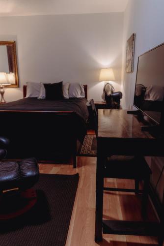 a bedroom with a bed and a dog sitting on a desk at Cozy private Guest House in Los Angeles
