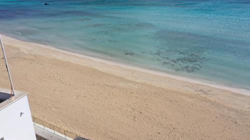 a view of the beach and the ocean at Salento Sottovento Luxury BeB in Torre Lapillo