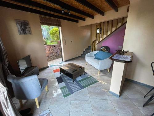 a living room with a couch and a table at LES VETYVERS in Grande Ravine