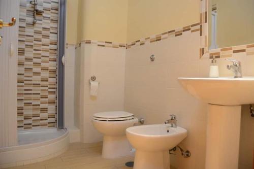 a bathroom with a toilet and a sink at Sant'Alfonso Rooms in Marina di Camerota