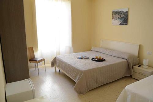 a bedroom with a bed with a plate of food on it at Sant'Alfonso Rooms in Marina di Camerota