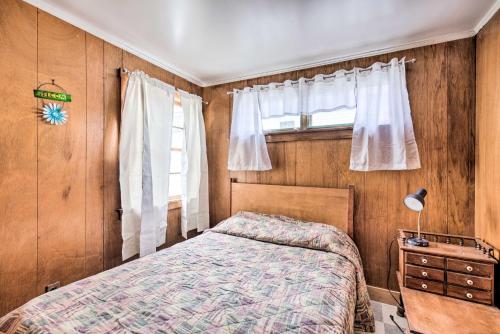 a bedroom with a bed and a window at Cozy Hampton Cottage with BBQ - Walk to Ocean! in Hampton