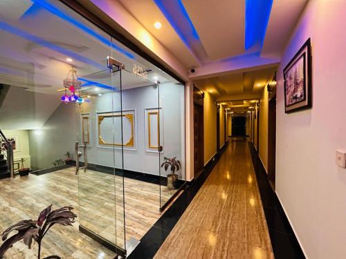 a room with a hallway with a glass wall at AAKAS Hotel & Restaurant in Muzaffarabad