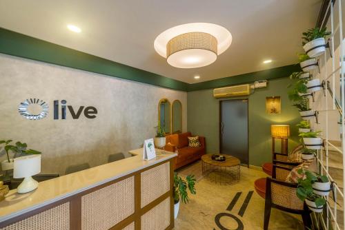 an office with a lobby with plants on the wall at Olive Rest House Road by Embassy Group in Bangalore