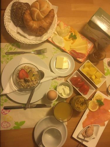 a table topped with plates of food and bread at Walenstadt in Seenähe B & B in Walenstadt