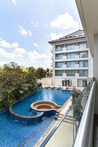 a swimming pool on the balcony of a building at Best Western Kamala Jimbaran in Jimbaran
