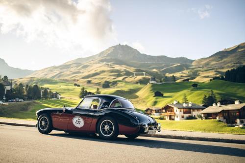 a car driving down a road with mountains in the background at Tschuggen Grand Hotel - The Leading Hotels of the World in Arosa