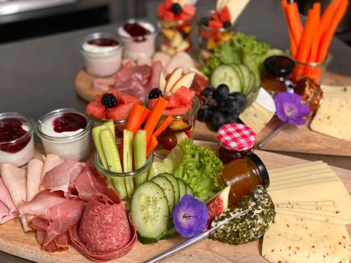 a bunch of different types of food on a table at Boutique Hotel Lindenhof, Bed & Breakfast in Aurich