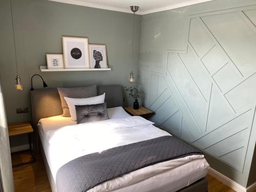 a small bedroom with a bed in a room at Boutique Hotel Lindenhof, Bed & Breakfast in Aurich