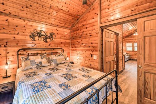 a bedroom with a bed in a log cabin at Charming New Bern Log Cabin - Pets Welcome! in New Bern