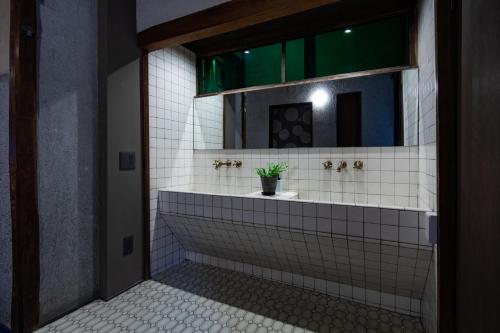 a bathroom with a sink and a mirror at UNKNOWN KYOTO in Kyoto