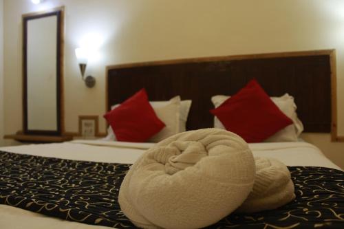 a towel animal sitting on top of a bed at Rainwood Residency in Lonavala