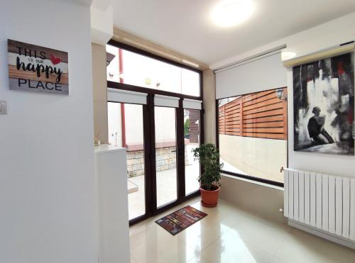 a hallway with large windows in a house at Studio'24 - Tomis Mall - Ultracentral in Constanţa